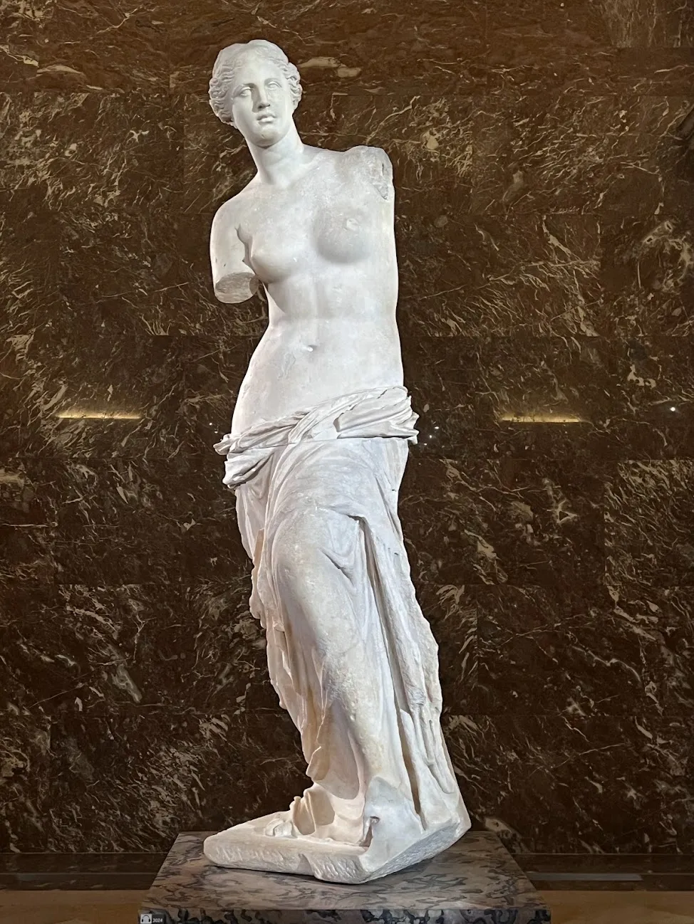 Marble sculpture of a topless woman without arms